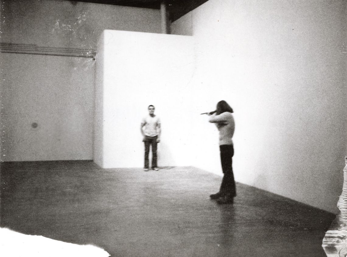 Chris Burden, Shoot (1971). F Space, Santa Ana, CA. November 19, 1971. At 7:45 p.m. I was shot in the left arm by a friend. The bullet was a copper jacket .22 long rifle. My friend was standing about fifteen feet from me. © Chris Burden. Courtesy of the artist and Gagosian Galler