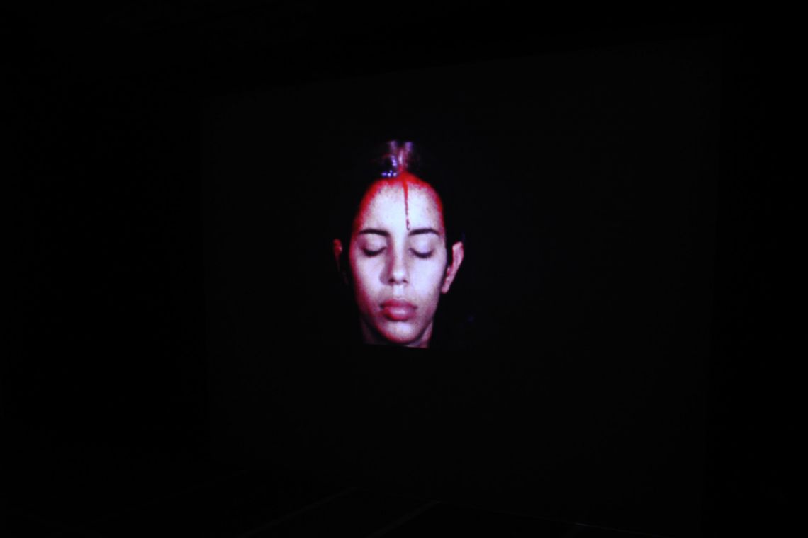 Ana Mendieta. Exhibition view of the super-8mm film transferred to high-definition digital media Sweating Blood (1973) at the III Venice International Performance Art Week 2016. Photograph by We Exhibit.